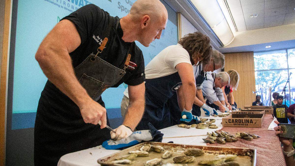 Jay Gallet, the nation’s fastest oyster-shucker, left, competes during NC Oyster Summit, Tuesday, May 9, 2023 at Marbles Kids Museum in Raleigh.