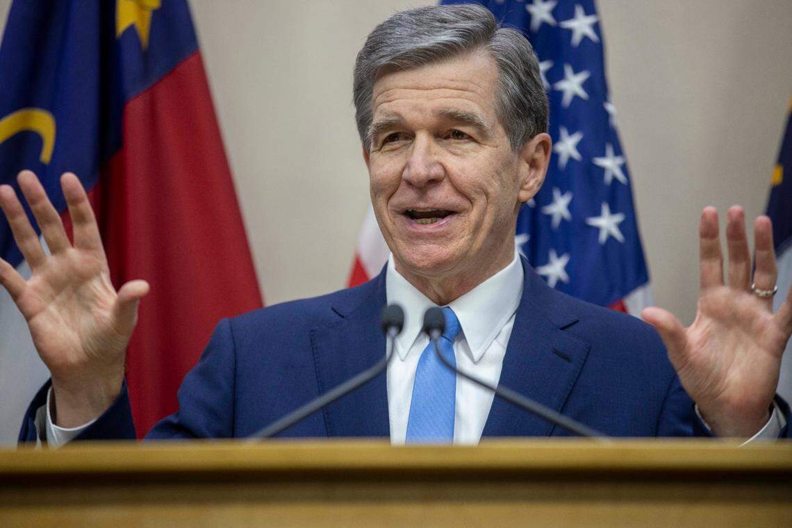 North Carolina Governor Roy Cooper announces that he will sign the state budget, during a press briefing on Tuesday, November 16, 2021 in Raleigh, N.C.