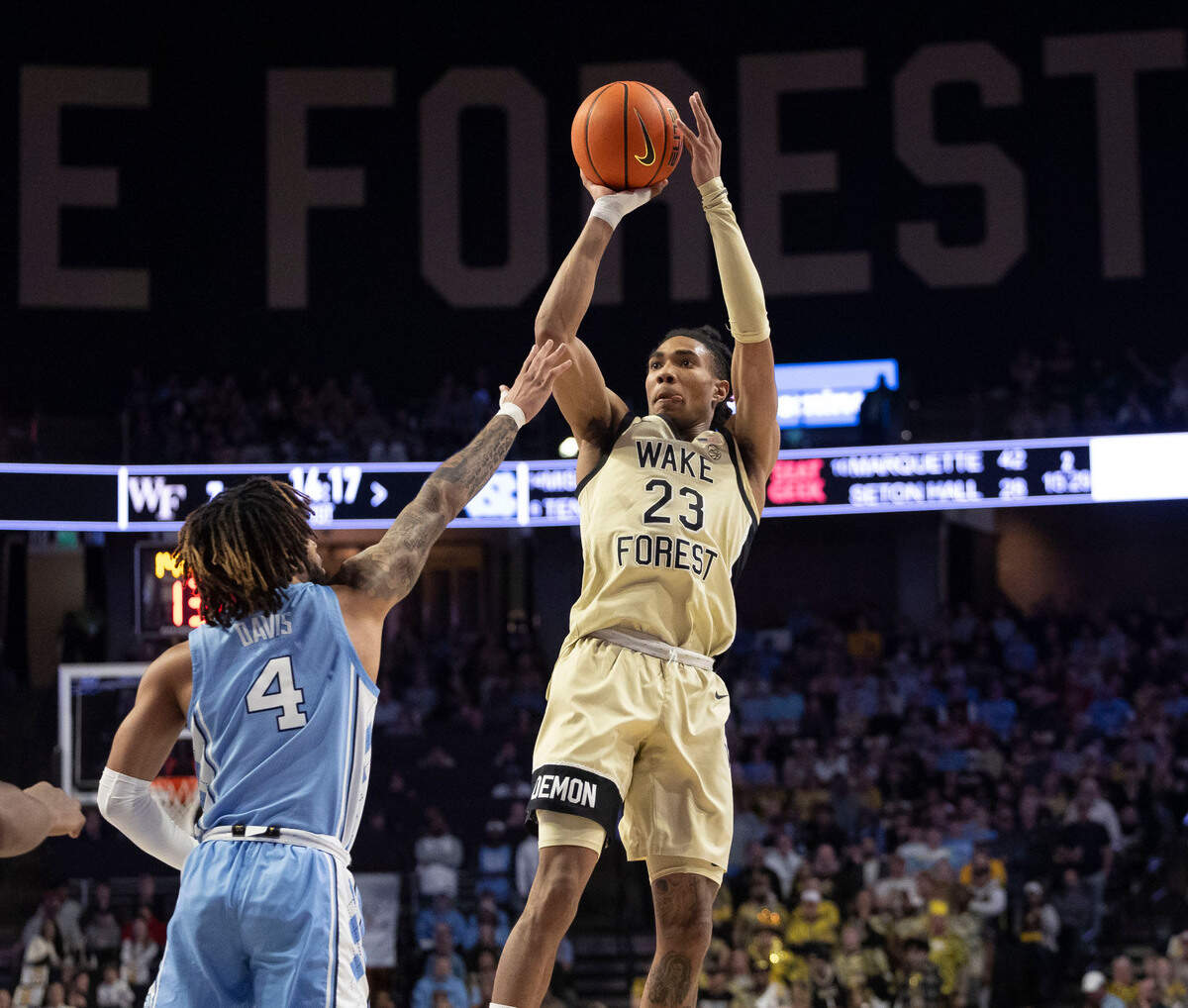 Wake Forest’s Hunter Sallis (23) puts up a shot over North Carolina guard R.J. Davis (4) in the first half on Tuesday, January 21, 2025 at Lawrence Joel Coliseum in Winston-Salem, N.C.