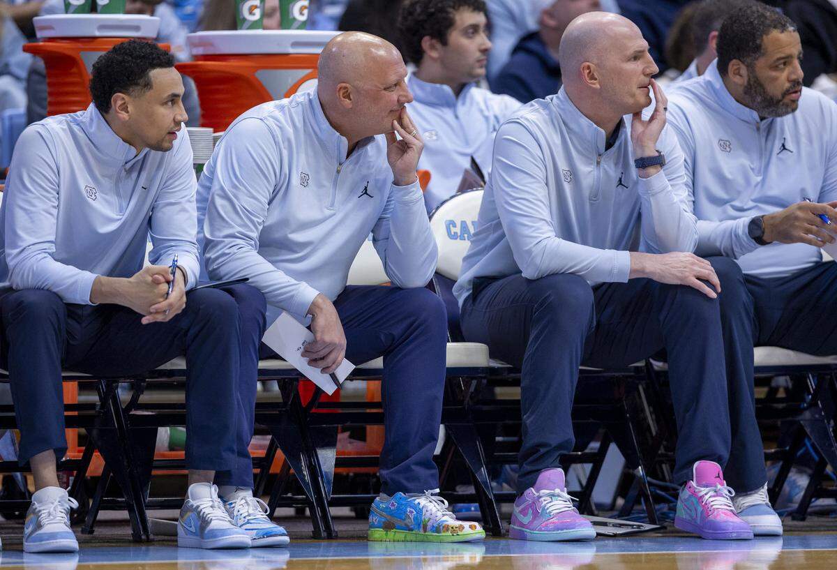 North Carolina assistant coaches Marcus Paige, Jeff Lebo, Brad Frederick and Sean May sport pairs of custom painted shoes on Monday, February 2, 0226 at the Smith Center in Chapel Hill, N.C. The shoes were painted by patients from UNC Children’s Hospital as part of a fundraiser for pediatric cancer research.
