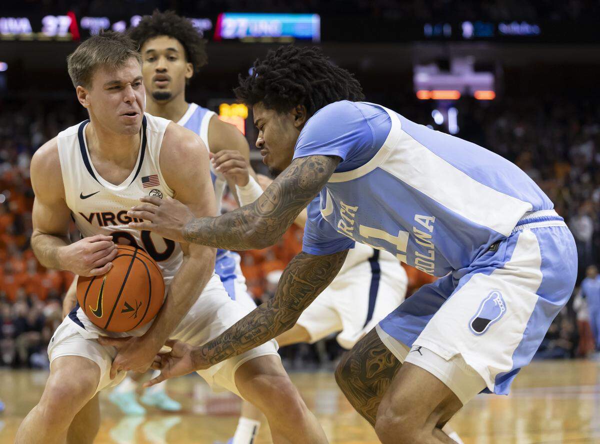 Virginia guard Dallin Hall (30) secures a defensive rebound against North Carolina guard Jonathan Powell (11) in the first half on Saturday, January 24, 2026 at John Paul Jones Arena in Charlottesville, Va.