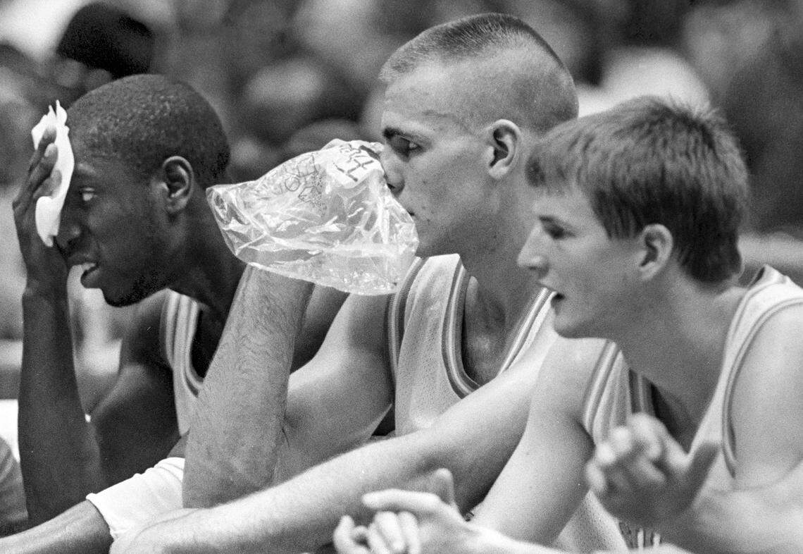 UNC center Eric Montross (center) holds ice to his face as forward Brian Reese holds a towel to his during a physical NCAA Tournament game.