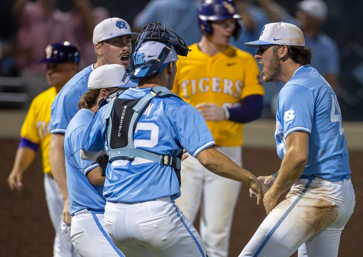 North Carolina teammates Hunter Stokely (45), Patrick Alvarez (8) and Luke Stevenson (44) celebrate with closing pitcher Dalton Pence (49) after defeating LSU 4-3 in the tenth inning clinching their NCAA Regional on Monday, June 3, 2024 at Boshamer Stadium in Chapel Hill, N.C.
