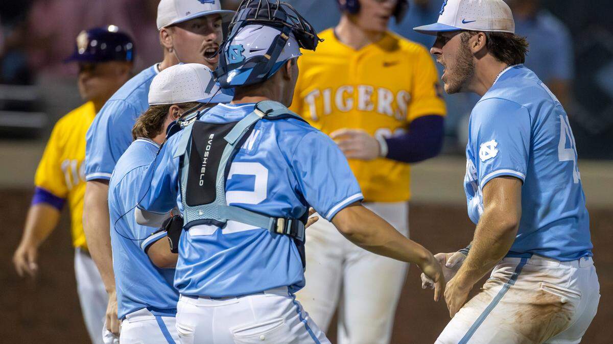 North Carolina teammates Hunter Stokely (45), Patrick Alvarez (8) and Luke Stevenson (44) celebrate with closing pitcher Dalton Pence (49) after defeating LSU 4-3 in the tenth inning clinching their NCAA Regional on Monday, June 3, 2024 at Boshamer Stadium in Chapel Hill, N.C.