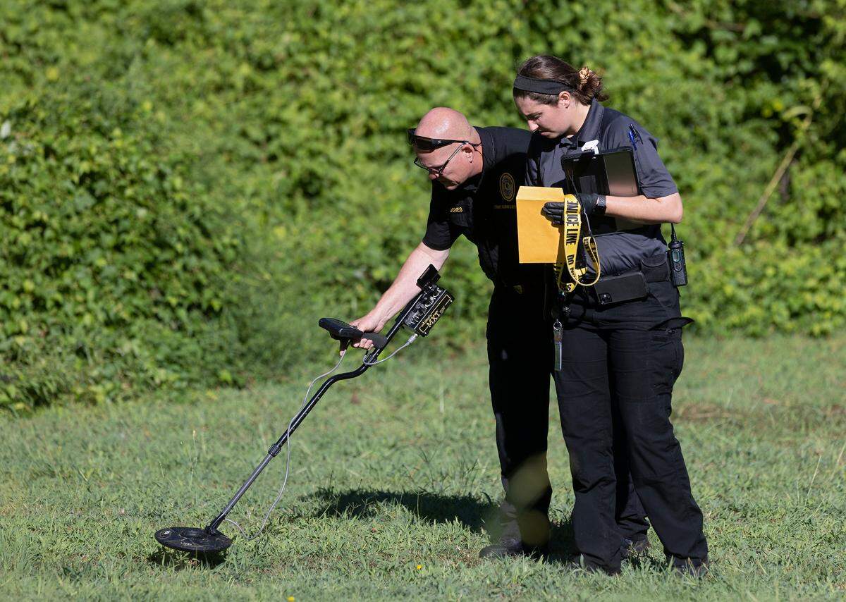 Forensic investigators work the scene near the intersection of Branch and East Streets in Raleigh, N.C. after a State Highway Patrol trooper shot and killed a 20-year-old man during an exchange of gunfire early Friday morning, Sept. 1, 2023.