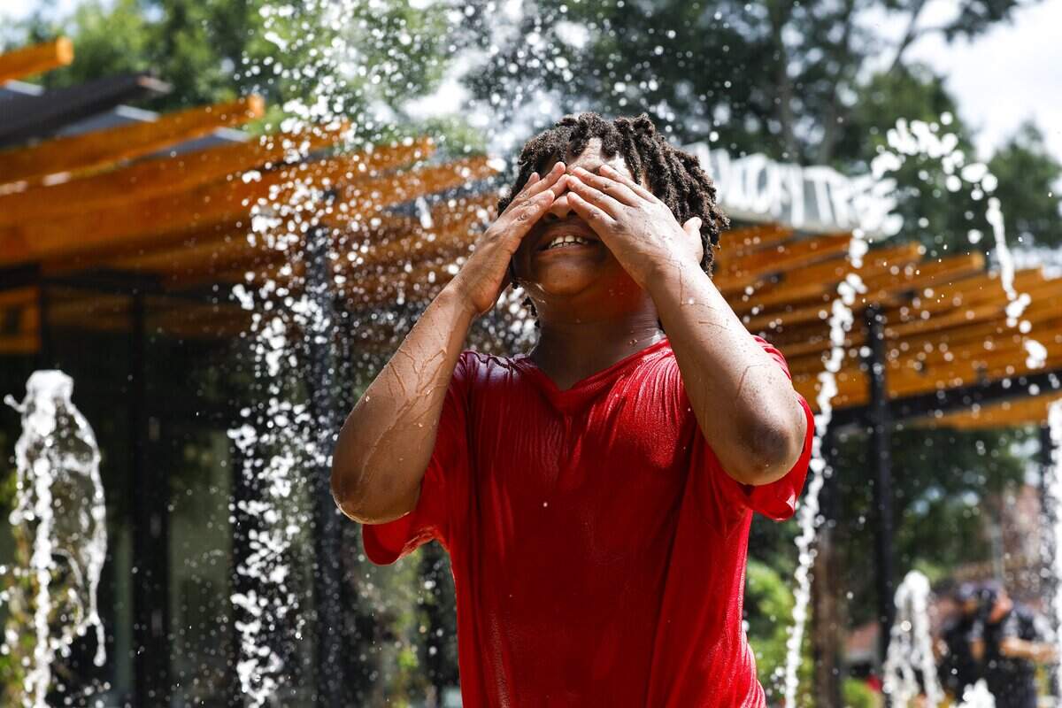 Ariana Nabors cooled off in the splash pad at Moore Square with her brother Ishmael on Monday, June 29, 2026, in downtown Raleigh.
