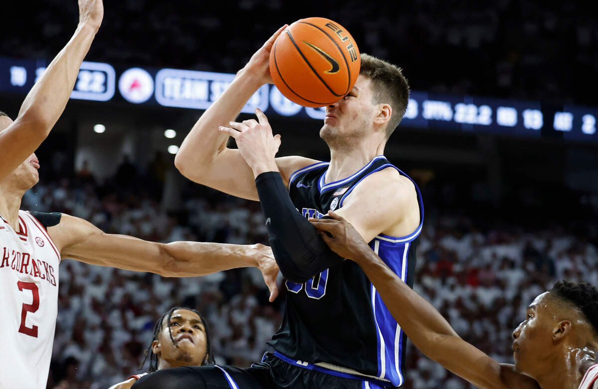 Duke’s Kyle Filipowski (30) is fouled as he heads to the basket during the first half of Duke’s game against Arkansas at Bud Walton Arena in Fayetteville, Ark., Weds. Nov. 29, 2023.