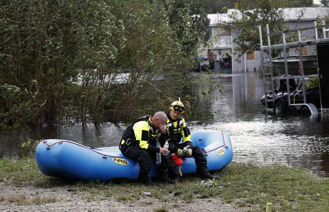 Members of a combined New Bern/Greenville swift water rescue team Brad Johnson, left, and Steve Williams rest after searching for people stranded by floodwaters caused by the tropical storm Florence in New Bern, N.C., on Saturday Sept. 15, 2018.