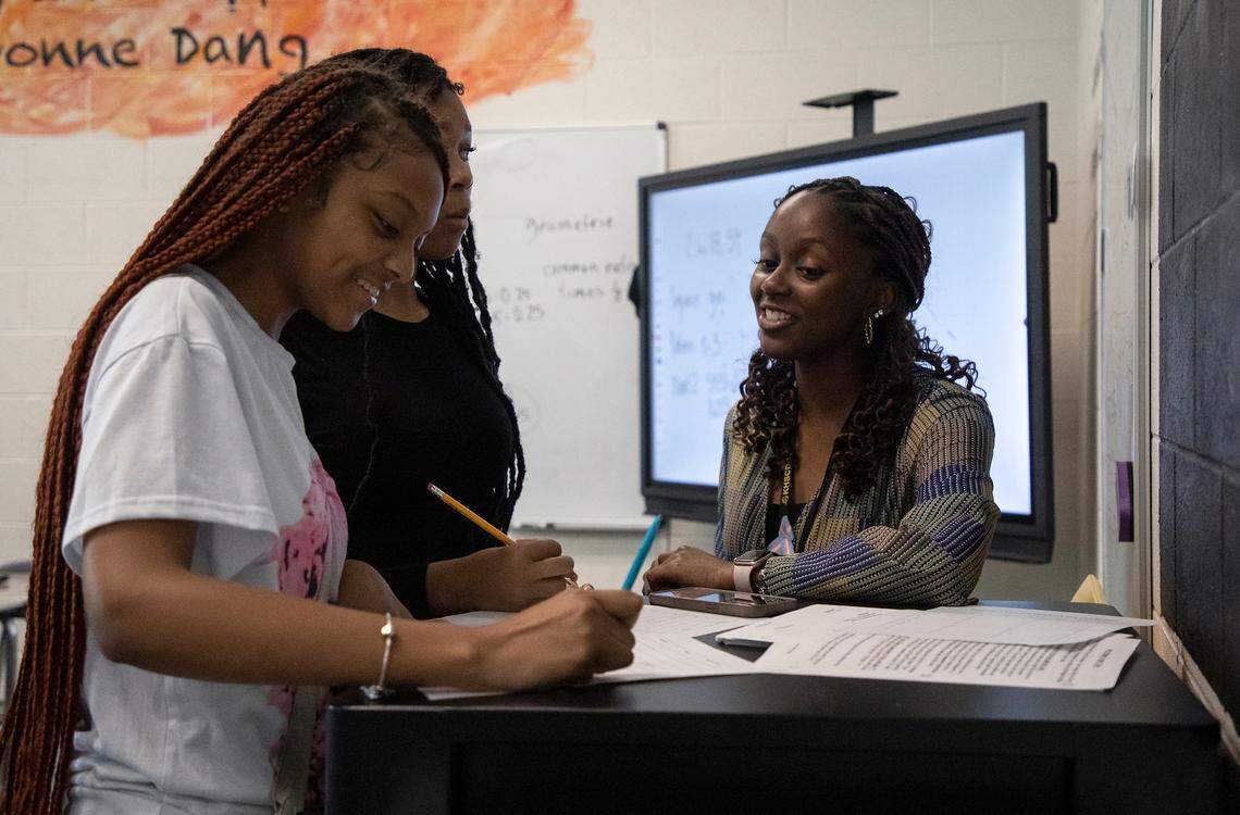 Knightdale High School teacher Alex Johnson works with Anisha Tann and Amya Reade during a math class on Tuesday, Sept. 5, 2023, in Knightdale, N.C.