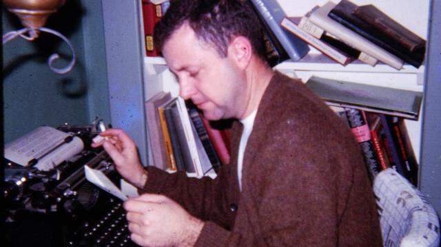 Gene Price at his typewriter.
