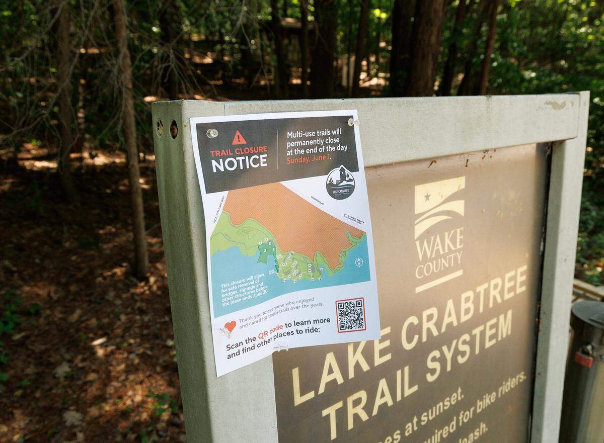 A sign announces the June 1st closure of multiuse trails at Lake Crabtree County Park, as pictured on Thursday, May 1, 2025, in Morrisville, N.C.