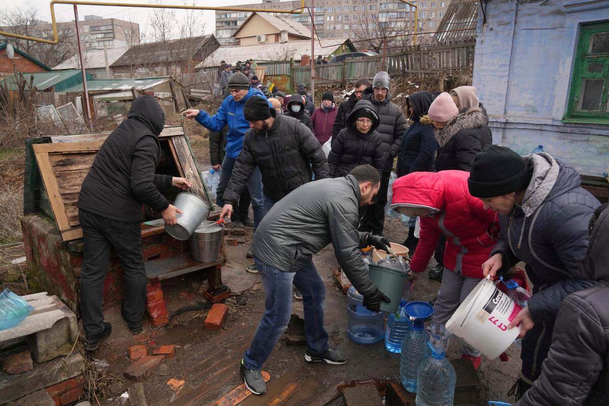 People line up to get water at the well in outskirts of Mariupol, Ukraine, Wednesday, March 9, 2022. A Russian attack has severely damaged a maternity hospital in the besieged port city of Mariupol, Ukrainian officials say.