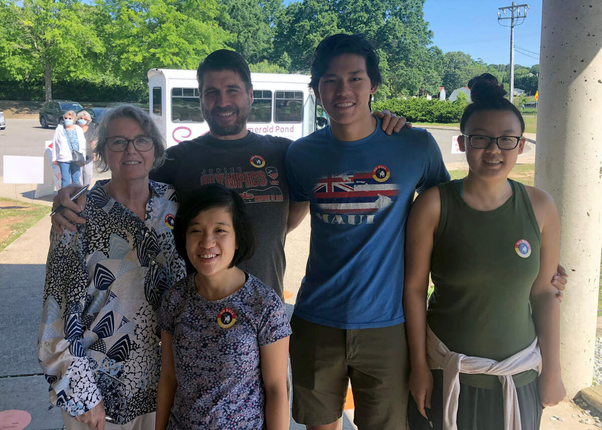 Mark Congiusta, designer of Durham’s voting sticker, pictured with his wife and three kids after voting in the primary election on May, 17 2022. The popular design will be used until 2024.