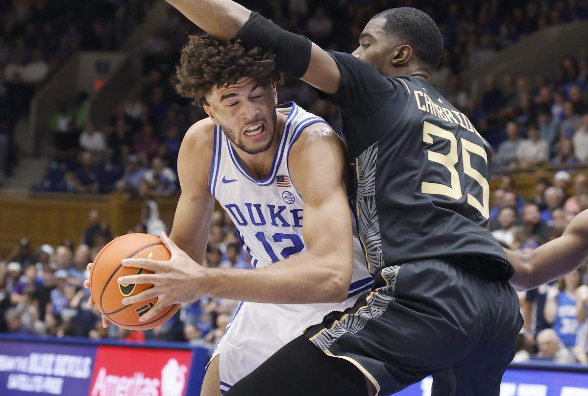Duke’s Cameron Boozer (12) tries to get around UCF’s Devan Cambridge (35) during the first half of Duke’s exhibition game against UCF at Cameron Indoor Stadium in Durham, N.C., Tuesday, Oct. 21, 2025.