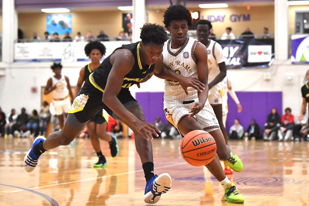 Prolific Prep’s N’Famara Debo (11) and Word of God’s Trey Greene (3) compete for the loose ball in the first half. The Word of God Holy Rams and Prolific Prep (CA) met in the John Wall Holiday Invitational in Raleigh, N.C. on December 30,2022 .