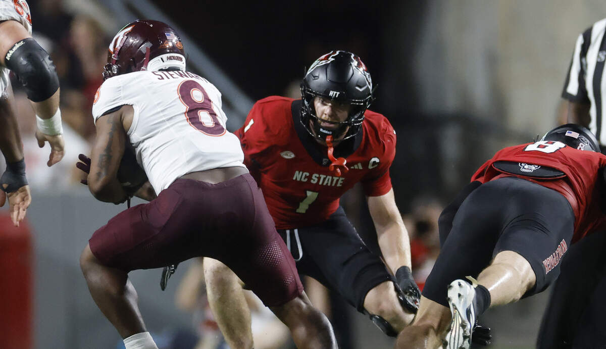Virginia Tech running back Terion Stewart (8) gets by N.C. State’s Cian Slone (8) and Caden Fordham (1) during the first half of N.C. State’s game against Virginia Tech at Carter-Finley Stadium in Raleigh, N.C., Saturday, Sept. 27, 2025.
