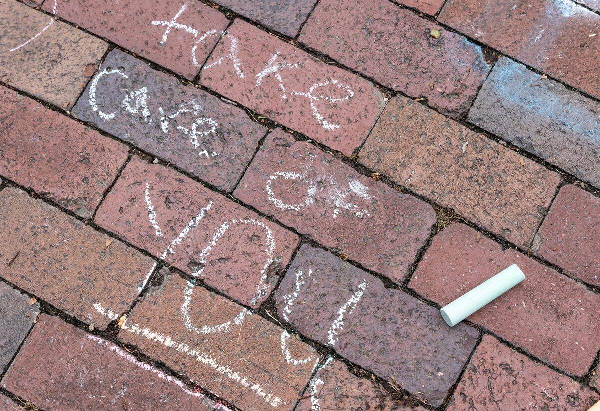 Messages are written in chalk on the quad of UNC-Chapel Hill on Tuesday, Aug. 29, 2023, following a Monday shooting that left a faculty member dead on the university campus.