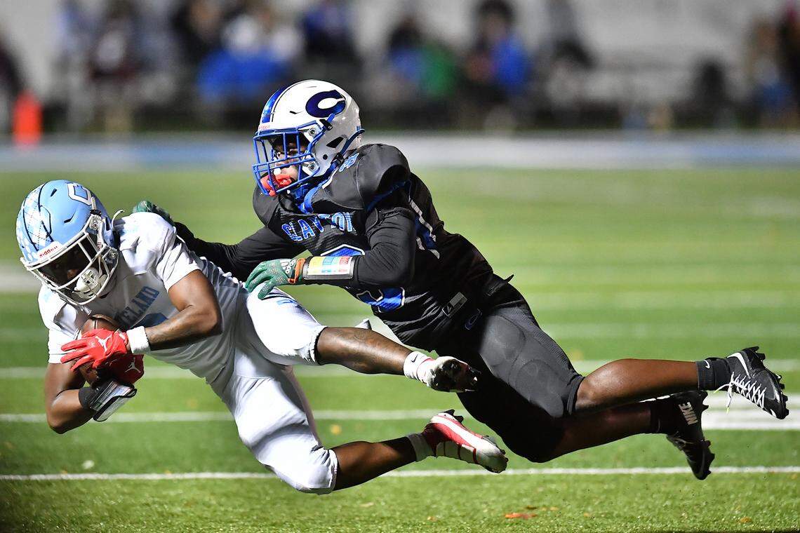 Cleveland running back Crishard Pettaway (7) is tackled by Clayton free safety Tashaun Walker (3) during the first half.  The Cleveland Rams took on the Clayton Comets in a conference football game in Clayton, N.C. on October 31st in Clayton, N.C.