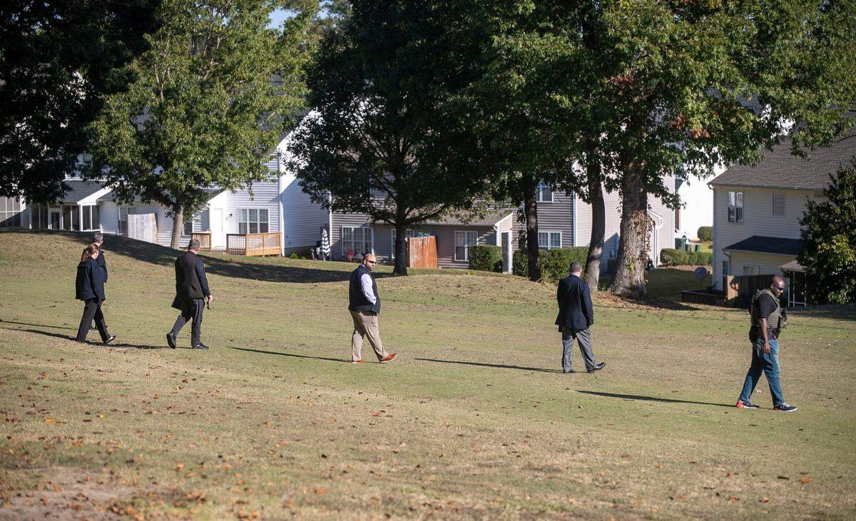 Raleigh Police detectives look for evidence along the golf course in the Hedingham neighborhood on Friday morning, October 14, 2022 in Raleigh, N.C. as they continue to investigate the shooting that killed 5 people, including an off-duty police officer.