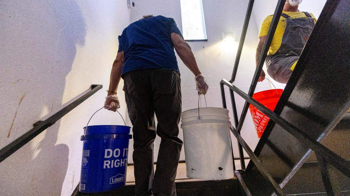 Volunteers organized by grassroots group BeLoved Asheville haul gray water to help residents in low-income independent living facilities, with no running water, flush their toilets on Wednesday, Oct. 9, 2024. About half of Asheville’s water customers were still without running water this week because the remnants of Hurricane Helene ripped apart the city’s distribution system.