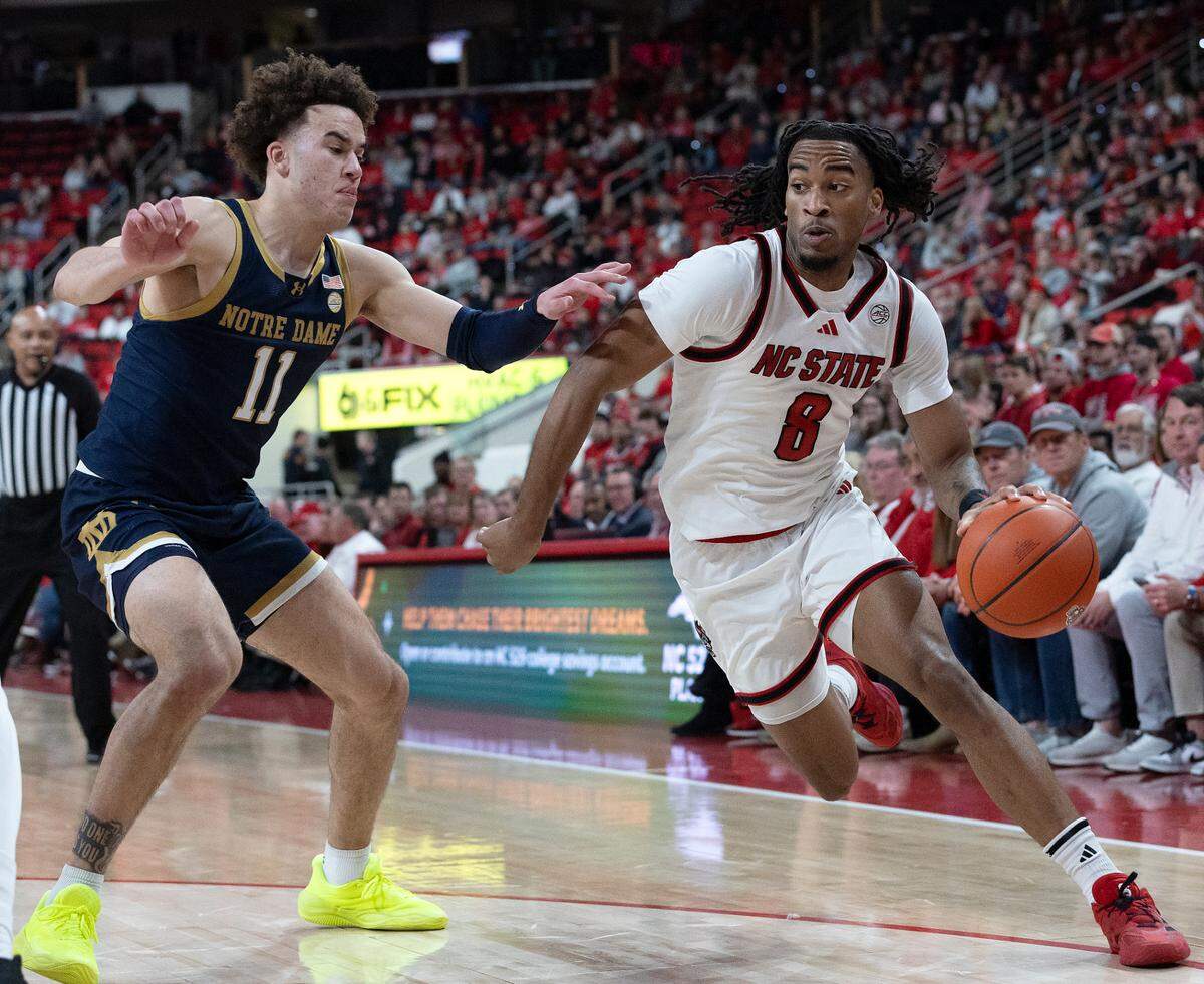 N.C. State’s Jayden Taylor drives past Notre Dame’s Braeden Shrewsberry during the first half of the Wolfpack’s 66-65 win on Wednesday, Jan. 8, 2025, at Lenovo Center in Raleigh, N.C.