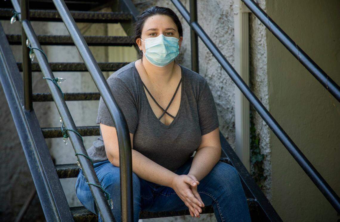 For a portrait outside her home, Emily Richardson wears the protective mask she would have worn to her shift two days prior as a Ceritified Nursing Assistant at Carolina Reserve of Durham, an assisted living facility, when they would not allow her to start the shift wearing a mask while she cared for patients and fired her, on Thursday, Apr. 9, 2020, in Durham, N.C. She says Carolina Reserve has since changed their policy to require masks for their staff.