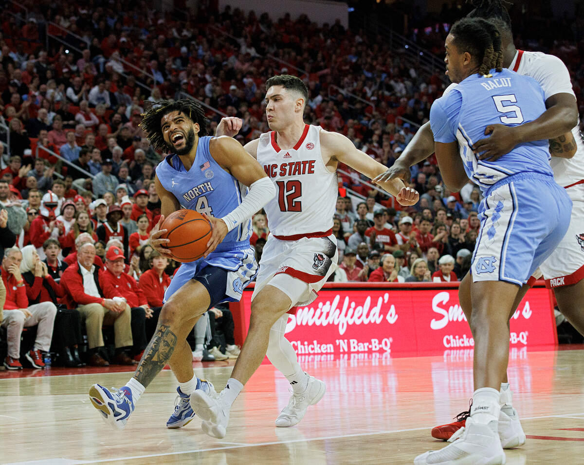 North Carolina’s RJ Davis drives to the basket past N.C. State’s Michael O’Connell during the first half of the Tar Heels’ 67-54 win at PNC Arena on Wednesday, Jan. 10, 2024, in Raleigh, N.C.
