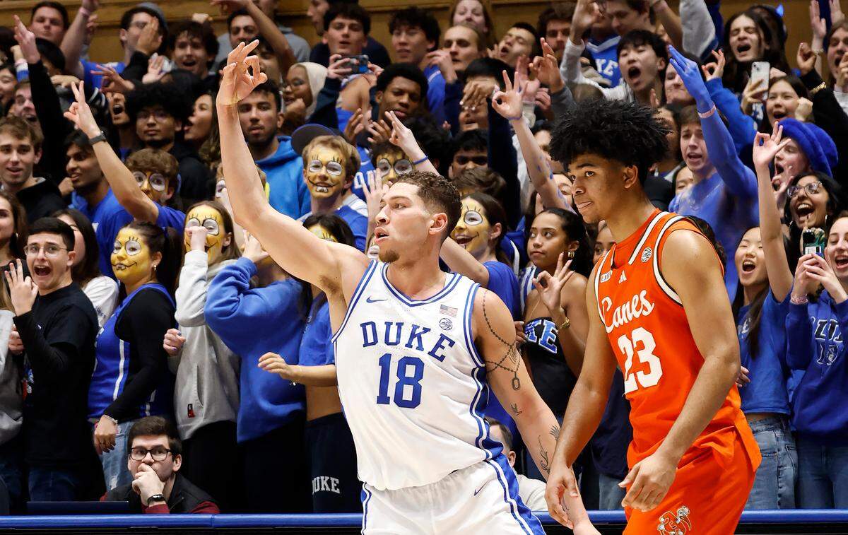 Duke’s Mason Gillis (18) celebrates a three-pointer in front of Miami’s Austin Swartz (23) during the first half of Duke’s game against Miami at Cameron Indoor Stadium in Durham, N.C., Tuesday, Jan. 14, 2025.