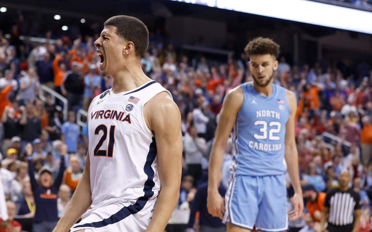 Virginia’s Kadin Shedrick (21) celebrates slamming in two as North Carolina’s Pete Nance (32) looks on during the second half of Virginia’s 68-59 victory over UNC in the quarterfinals of the ACC Men’s Basketball Tournament in Greensboro, N.C., Thursday, March 9, 2023.