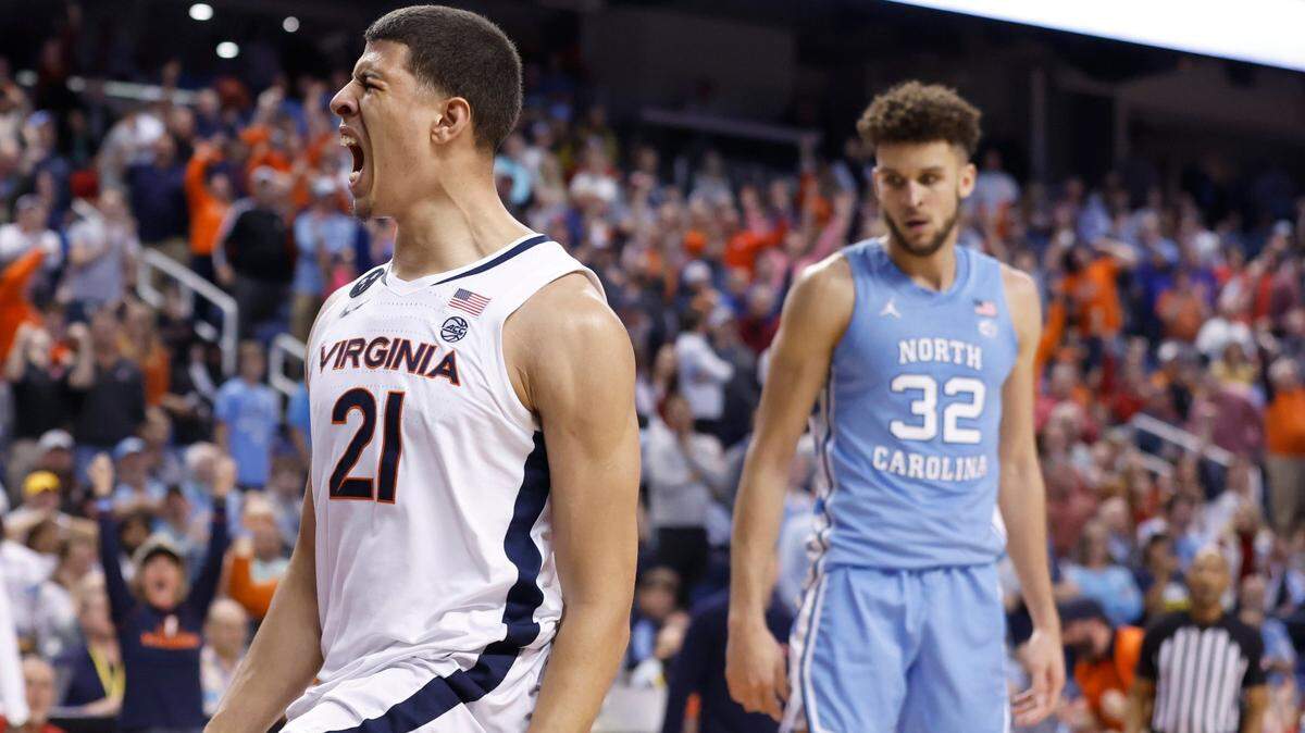 Virginia’s Kadin Shedrick (21) celebrates slamming in two as North Carolina’s Pete Nance (32) looks on during the second half of Virginia’s 68-59 victory over UNC in the quarterfinals of the ACC Men’s Basketball Tournament in Greensboro, N.C., Thursday, March 9, 2023.