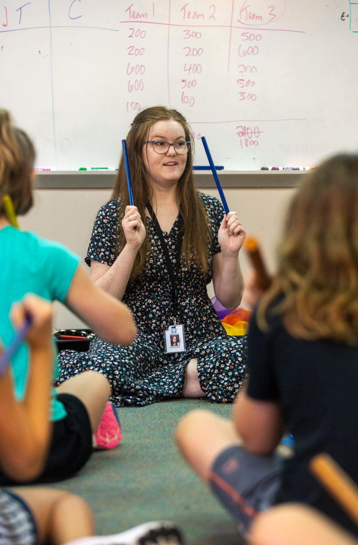 Liz Yardley, a recent college graduate has begun her teaching career at Sycamore Creek Elementary School. Yardley instructs a fifth grade class on how to read music and count beats using rhythm sticks on Tuesday, August 16, 2022 in Raleigh, N.C.