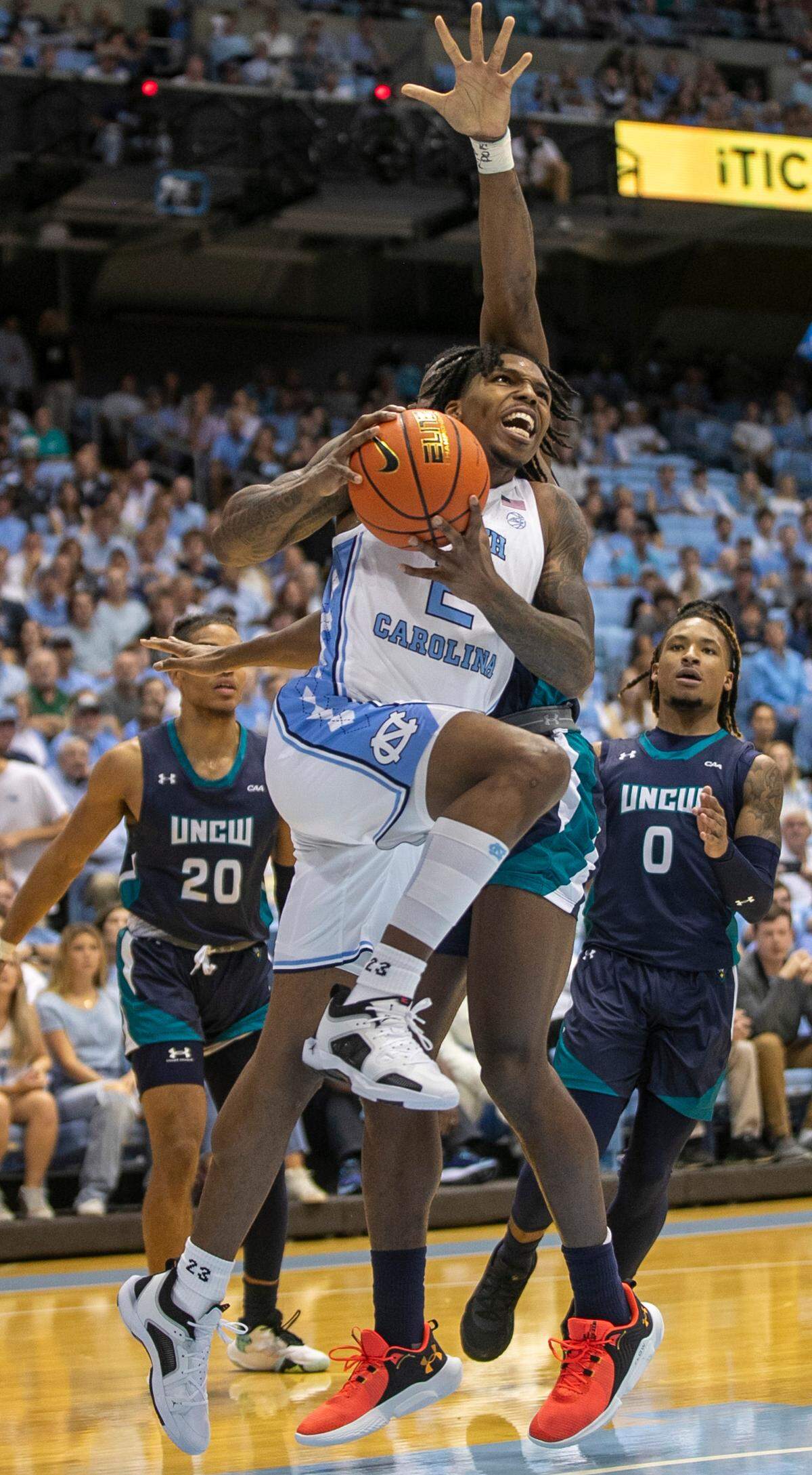 North Carolina’s Caleb Love (2) drives to the basket against UNC Wilmington’s Victor Enoh (12) during the first half on Monday, November 7, 2022 at the Smith Center in Chapel Hill, N.C.