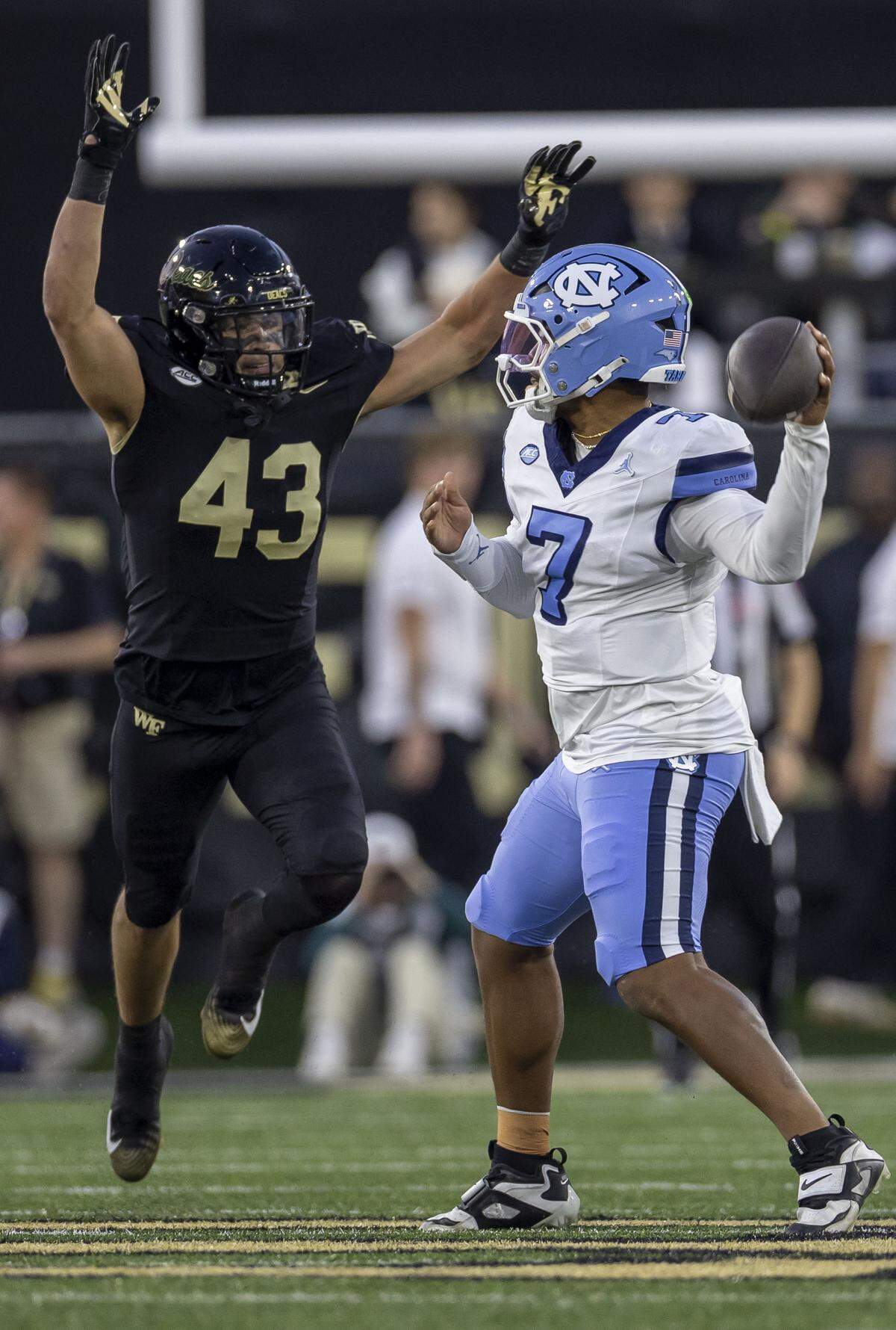 Wake Forest linebacker Frank Cusano (43) pressures North Carolina quarterback Gio Lopez (7) in the first quarter on Saturday, November 15, 2025 at Allegacy Stadium in Winston-Salem, N.C.