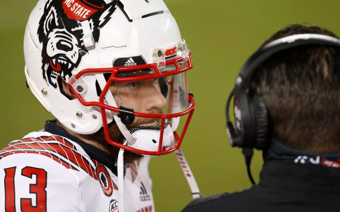 N.C. State quarterback Devin Leary (13) talks with offensive coordinator Tim Beck during the second half of Virginia Tech’s 45-24 victory over N.C. State at Lane Stadium in Blacksburg, VA Saturday, Sept. 26, 2020.