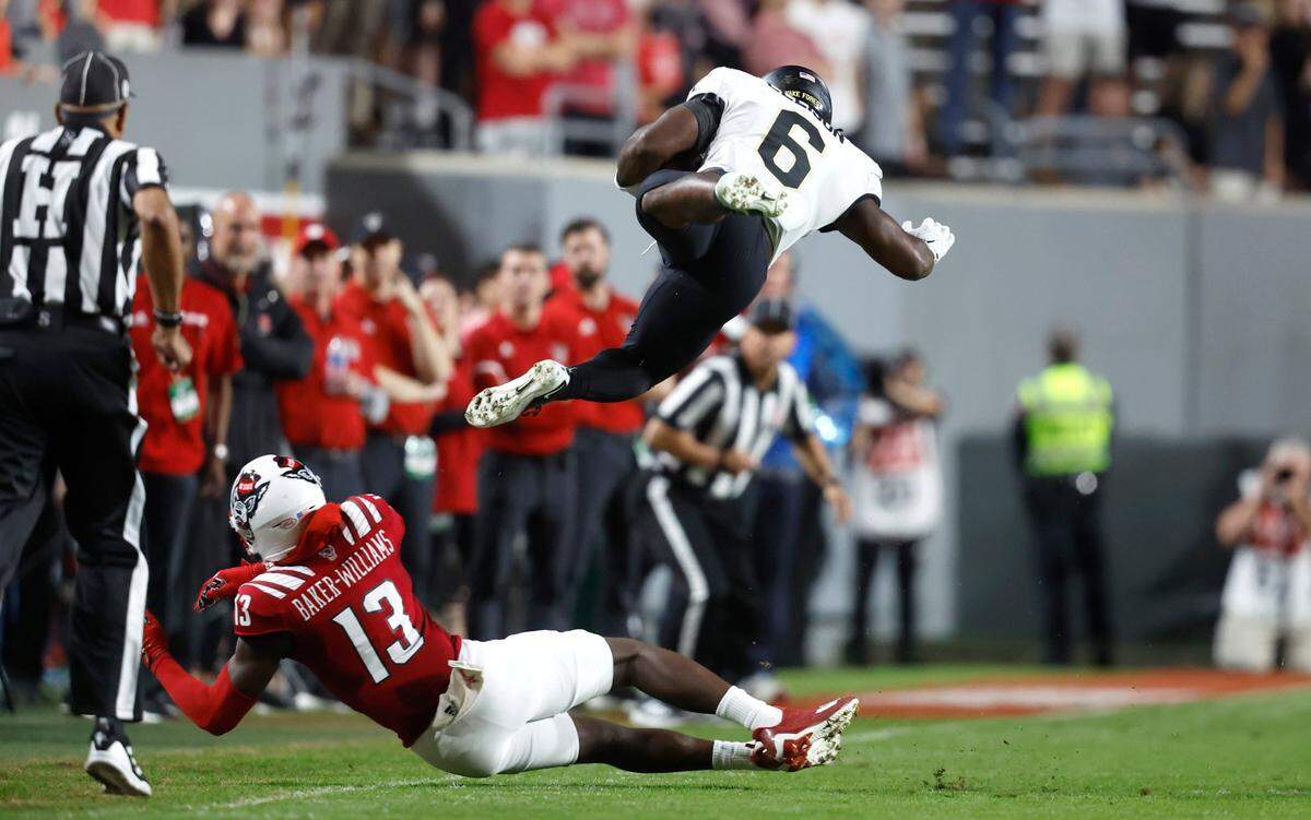 N.C. State’s Tyler Baker-Williams (13) tackles Wake Forest’s Justice Ellison (6) during the first half of N.C. State’s game against Wake Forest at Carter-Finley Stadium in Raleigh, N.C., Saturday, Nov. 5, 2022.