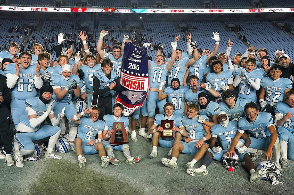 The Watauga Pioneers celebrate with the 6A Football Championship Trophy and banner after their defeat of Middle Creek. The Middle Creek Mustangs and the Watauga Pioneers met in the NCHSAA 6A Football Championship game in Chapel Hill, N.C. on December 12, 2025. 