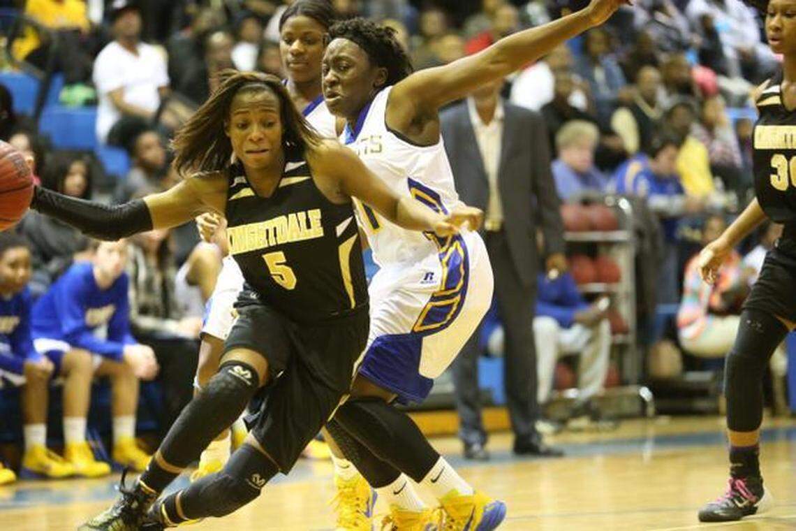 Knightdale’s Mikaya Wilson (5) spins around Garner’s Nia Jackson (21) on the baseline.