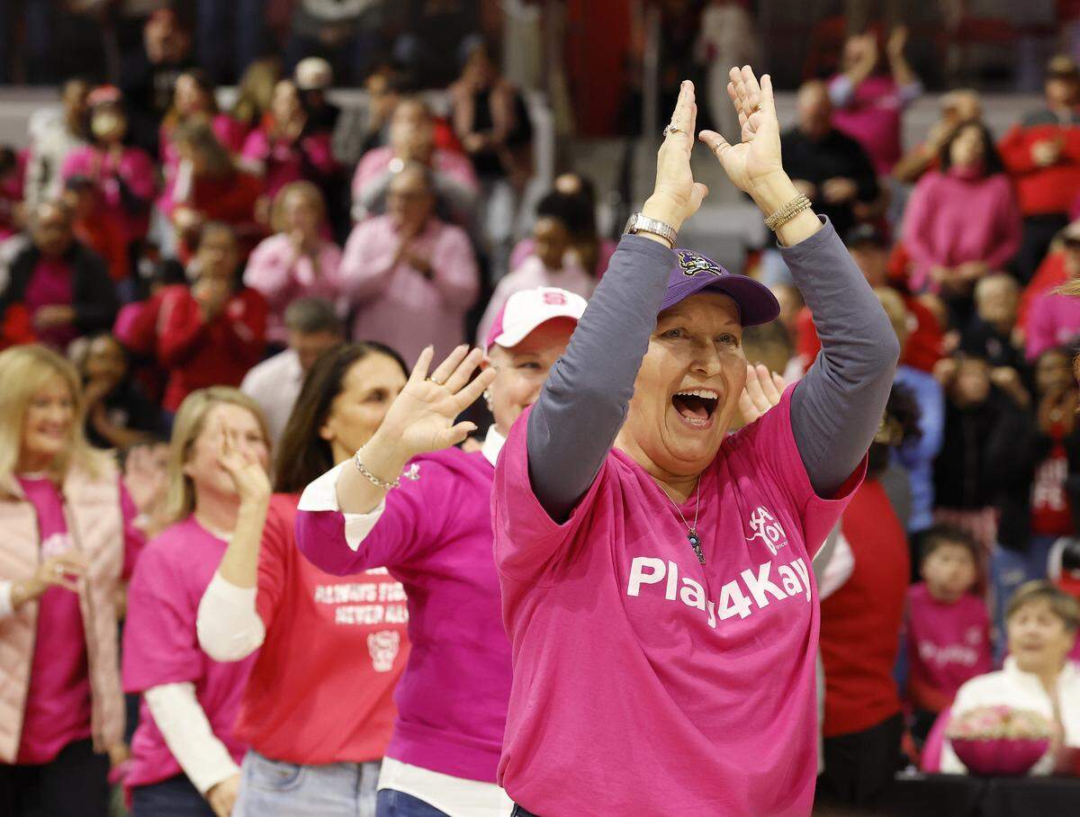 People take the court during a halftime ceremony to honor survivors of cancer during the 21st annual Play4Kay Game on Monday, Feb. 2, 2026, at Reynolds Coliseum in Raleigh, N.C. 