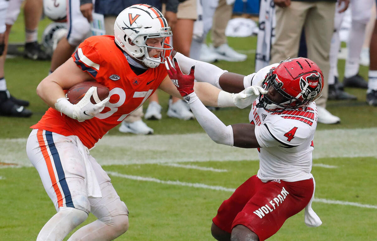 N.C. State cornerback Cecil Powell (4) comes in to tackle Virginia tight end Tony Poljan (87) during the second half of N.C. State’s 38-21 victory over Virginia at Scott Stadium in Charlottesville, Va., Saturday, Oct. 10, 2020.