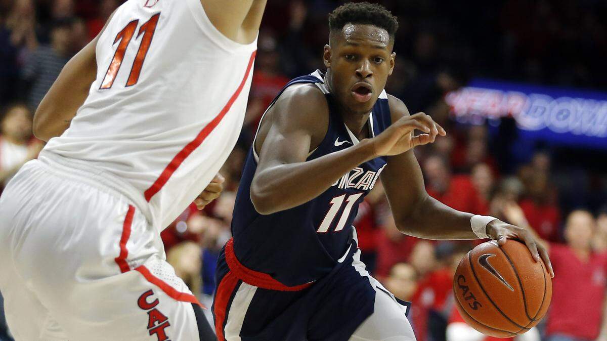 Gonzaga guard Joel Ayayi drives on Arizona forward Ira Lee (11) in the first half of an NCAA college basketball game, Saturday, Dec. 14, 2019, in Tucson, Ariz. (AP Photo/Rick Scuteri)