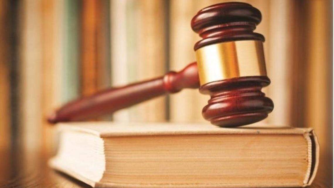 A judge’s gavel rests on a book of law.