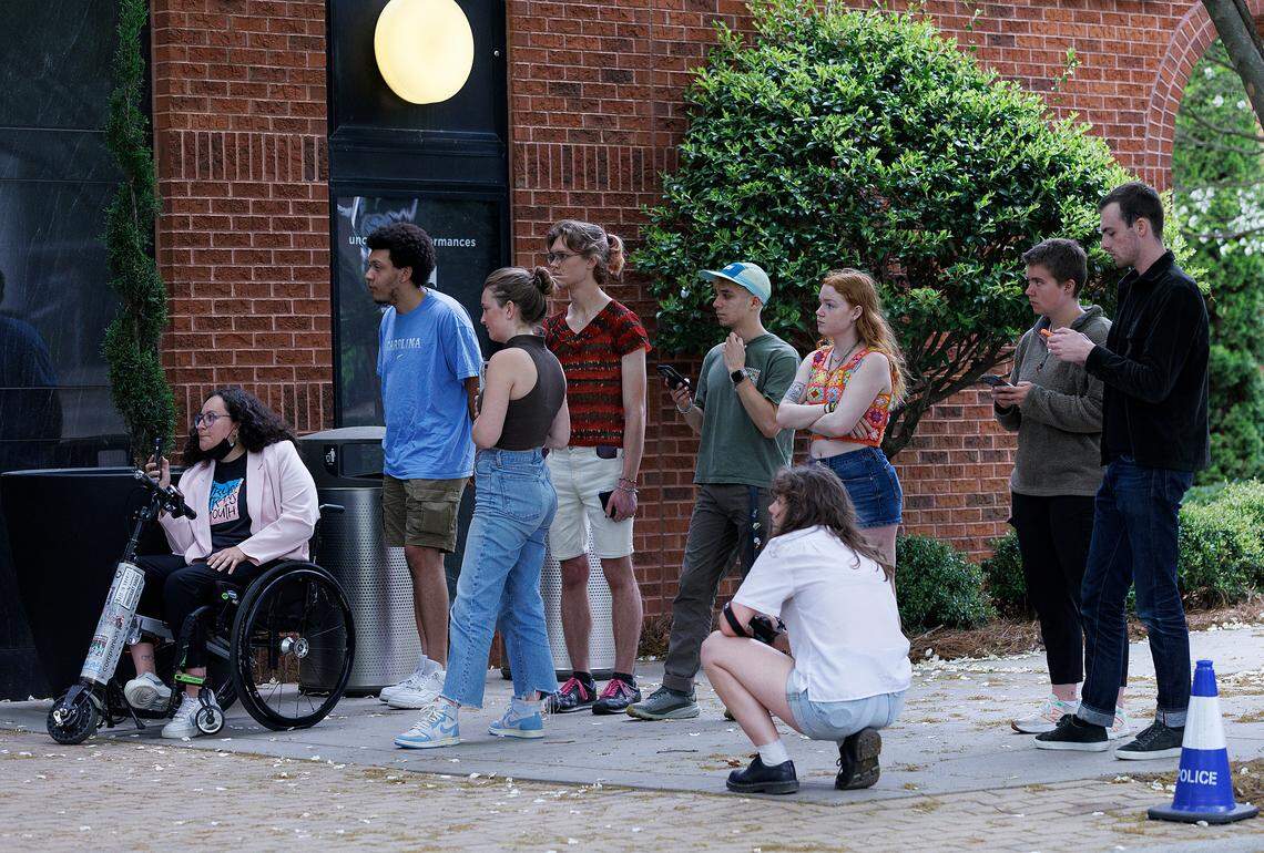 A group of students from UNC-Chapel Hill wait outside of the Alex Ewing Performance Place building on the campus of UNC School of the Arts after a meeting of the UNC System Board of Governors’ University Governance committee went into closed session on Wednesday, April 17, 2024, in Winston-Salem, N.C.