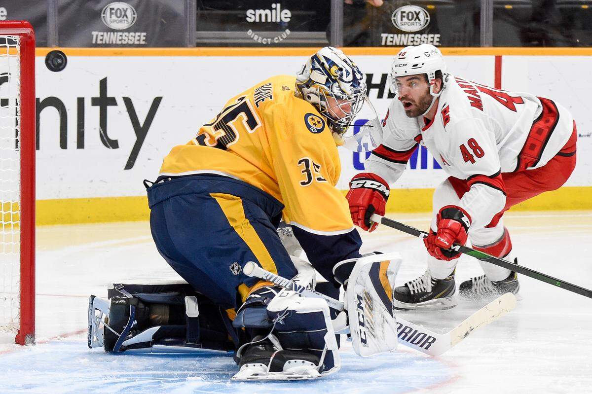A shot from Carolina Hurricanes left wing Jordan Martinook (48) misses the net past Nashville Predators goaltender Pekka Rinne (35) during the second period of an NHL hockey game in Nashville, Tenn., Monday, Jan. 18, 2021. (Andrew Nelles/The Tennessean via AP)
