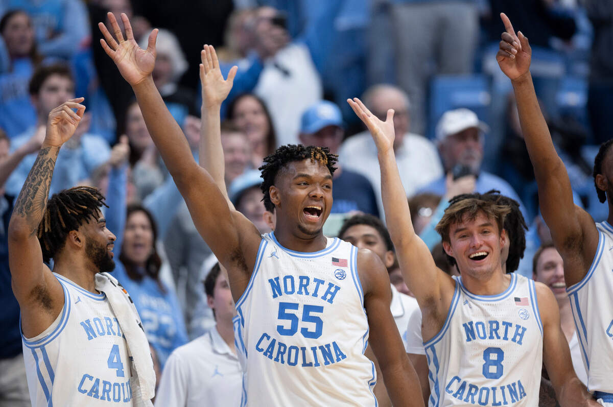 North Carolina’s Harrison Ingram (55) leads the celebration on the Tar Heels’ bench after James Okonkwo (32) hit a free-throw to break the century mark as North Carolina rolled to a 103-67 victory over Syracuse on Saturday, January 13, 204 at the Smith Center in Chapel Hill, N.C.