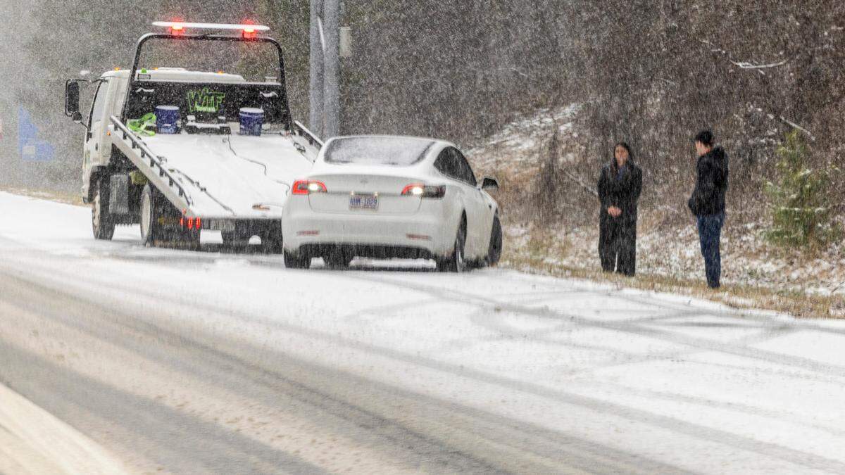 A tow truck operator works the scene of a disabled vehicle on I-40 in Raleigh on Wednesday, Feb. 19, 2024.