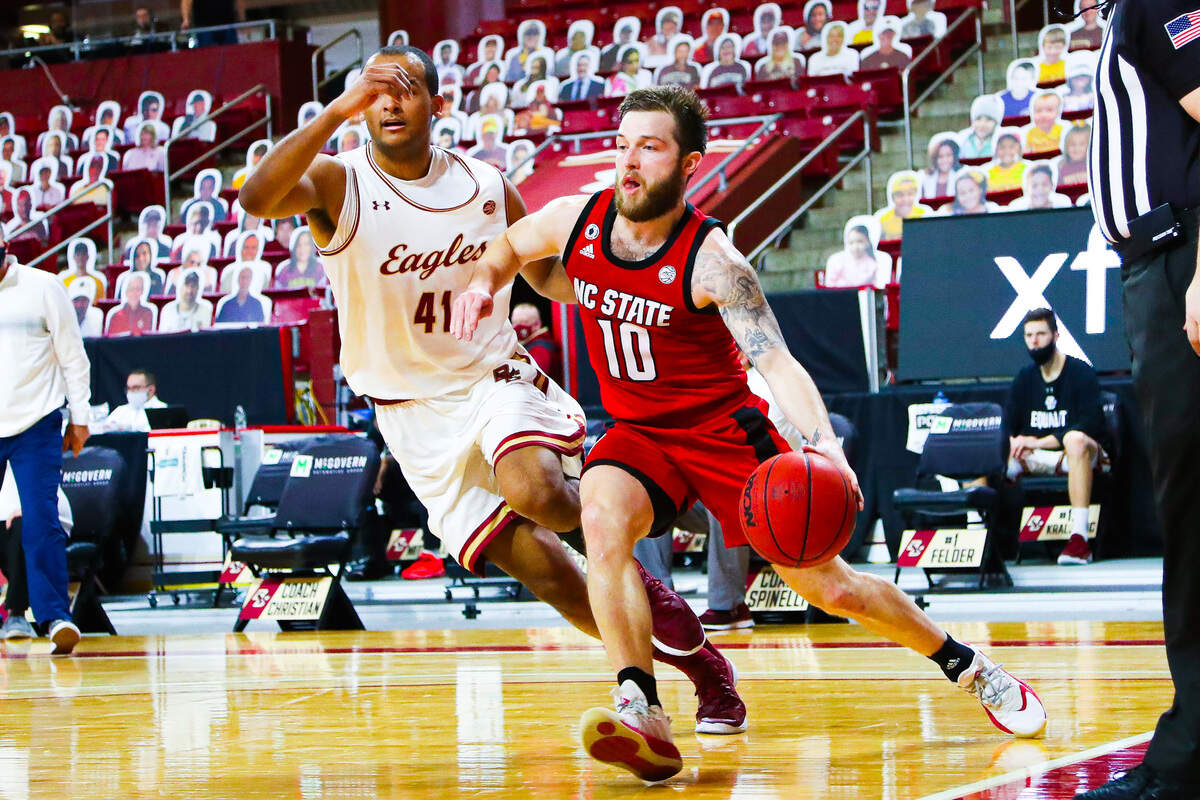 N.C. State guard Braxton Beverly drives against Boston College’s Steffon Mitchell in first half action Saturday, Feb. 6, 2021.