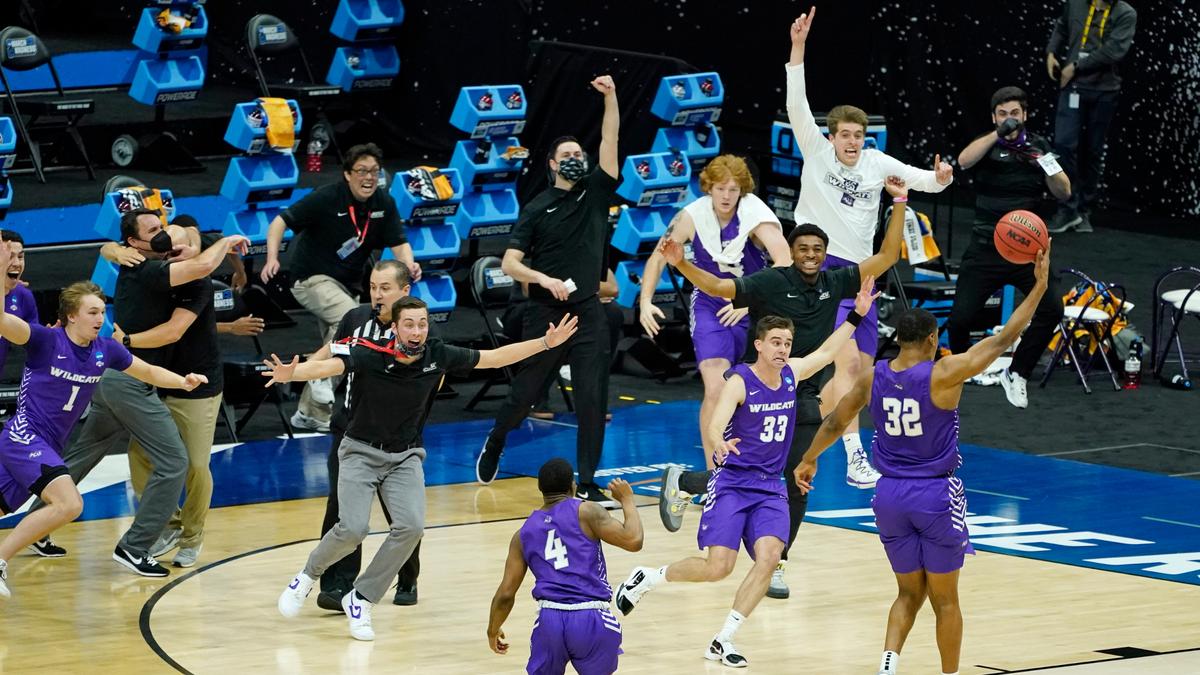 Abilene Christian players celebrate their 53-52 upset win over Texas in a college basketball game in the first round of the NCAA tournament at Lucas Oil Stadium in Indianapolis Sunday, March 21, 2021. 