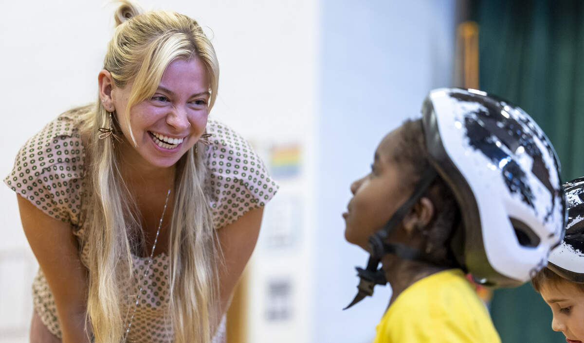 Green Magnet Elementary School kindergarten teacher Ashelyn Vinsel encourages her student Nasir Kingsberry, as students try out new bikes donated to the school by the Life Time Foundation, on Thursday, September 25, 2025 in Raleigh, N.C.