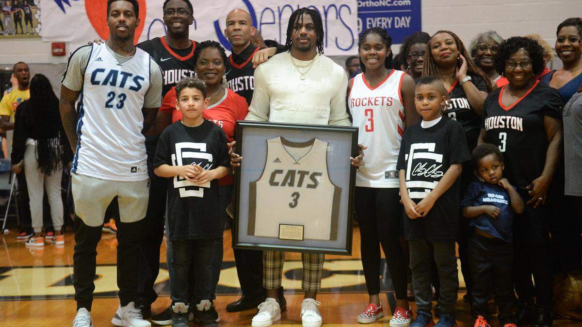 Chris Clemons, center, poses with fans during his jersey retirement ceremony that took place at Millbrook High School on February 14, 2020.