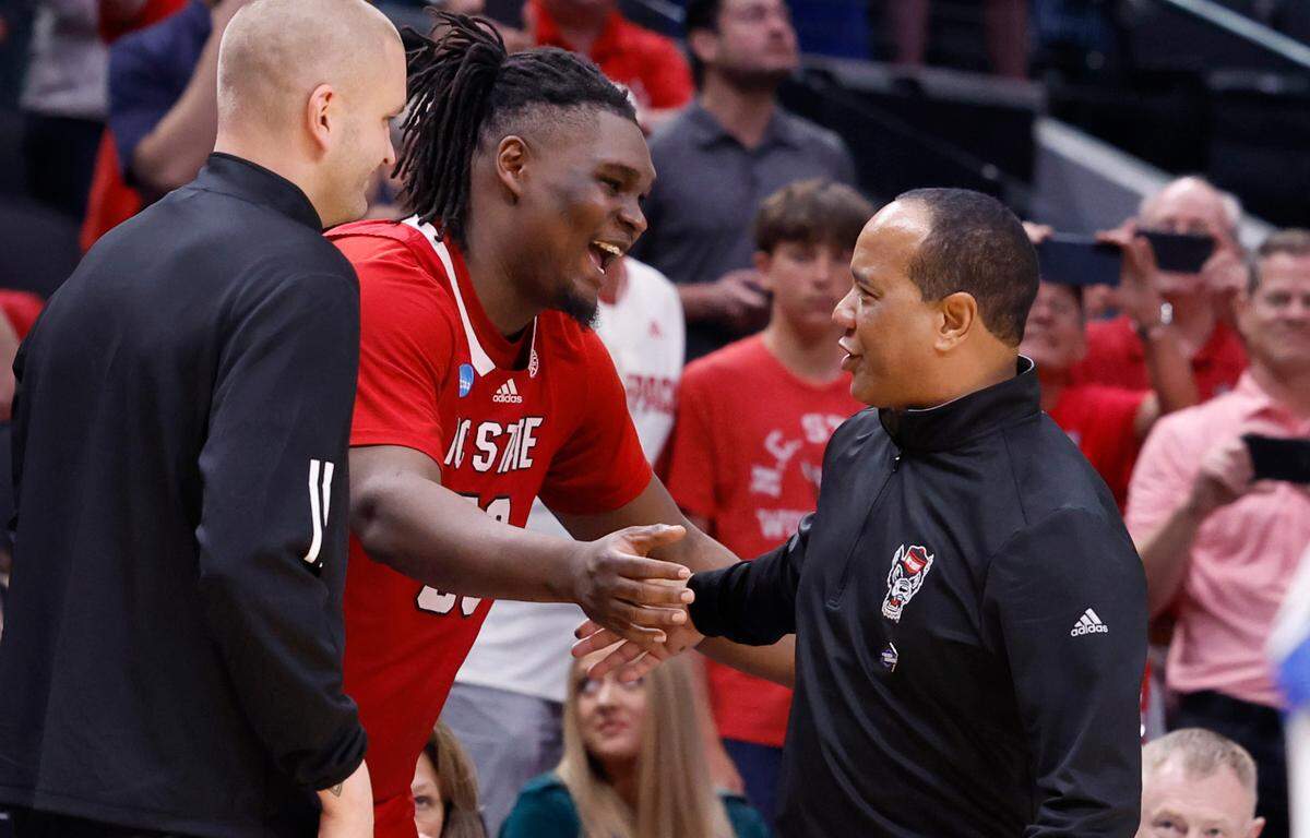 N.C. State’s DJ Burns Jr. celebrates with head coach Kevin Keatts in the final seconds of N.C. State’s 76-64 victory over Duke in their NCAA Tournament Elite Eight matchup at the American Airlines Center in Dallas, Texas, Sunday, March 31, 2024.